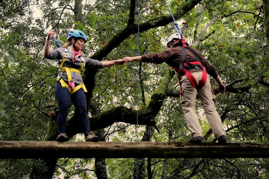 Two participants on high ropes course