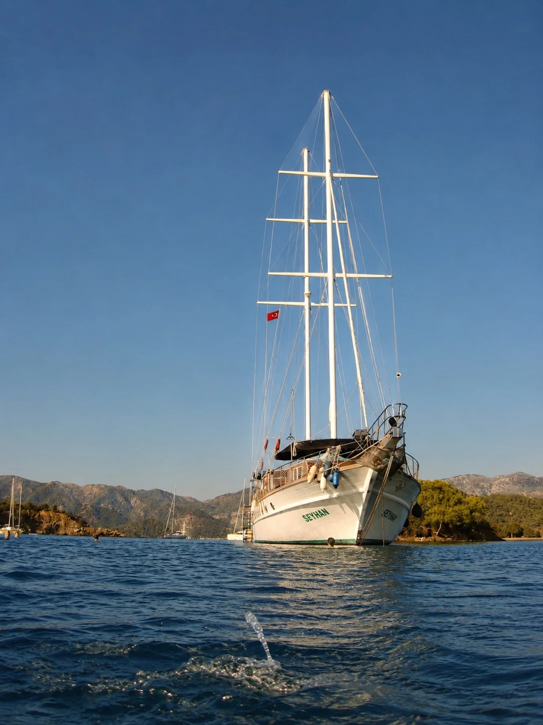 Sailing boat on calm blue water